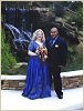 The Newlyweds smiling by the waterfall.